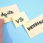 waterfall vs agile paper task on blue background, software devel