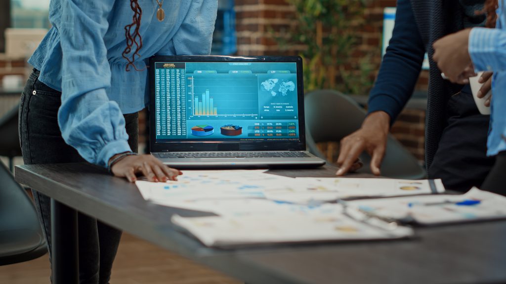 Coworkers examining reports on papers