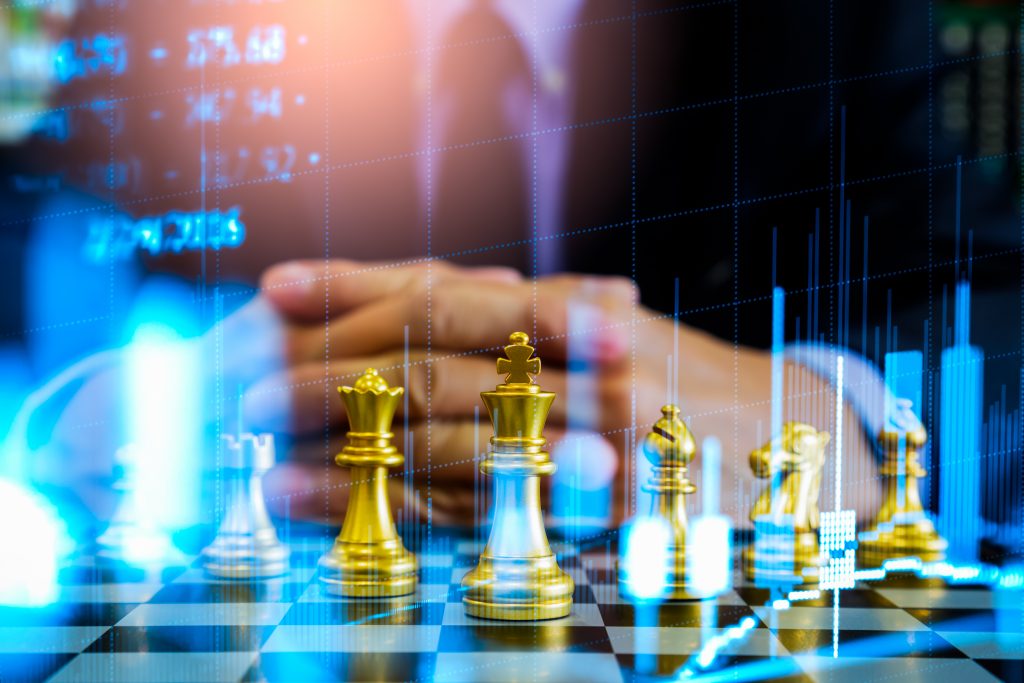 Chess game on chess board on stock market or forex trading graph