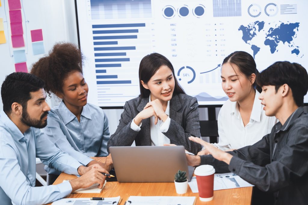 Multiracial analyst team use BI dashboard for data analysis with laptop. Concord