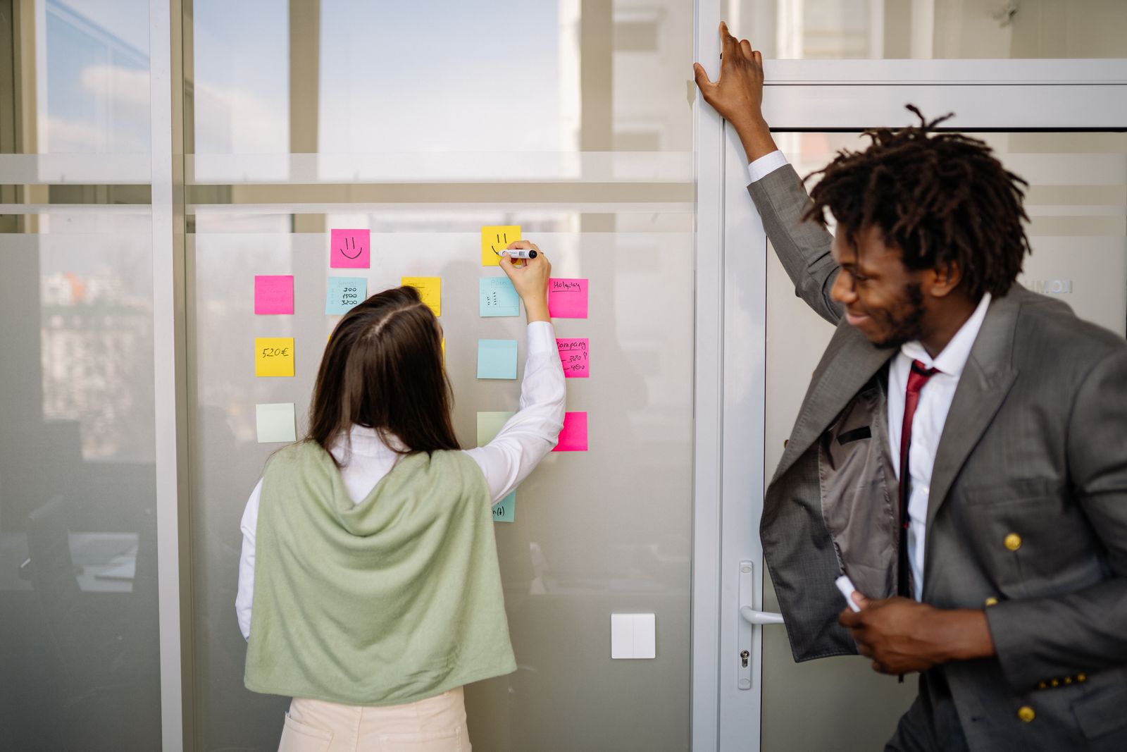 Tech team planning a no-code marketplace migration roadmap on a sticky note wall