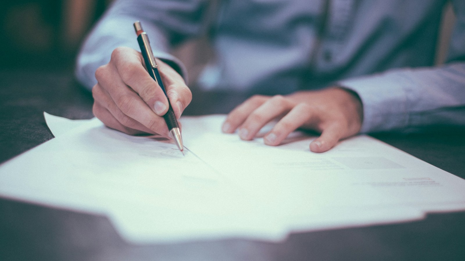 Professional drafting a migration plan on paper at a desk, representing the path from SaaS to custom marketplace