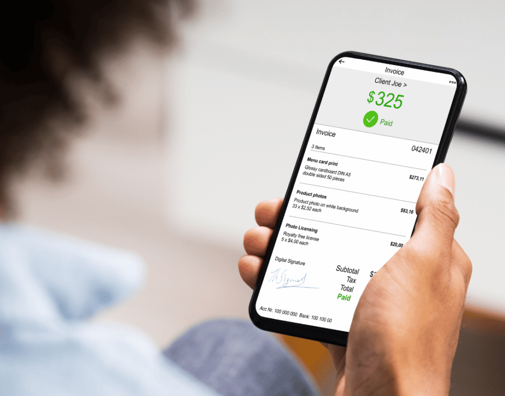 A paid invoice open on a phone screen, the customer-facing end of an e invoicing UAE pipeline