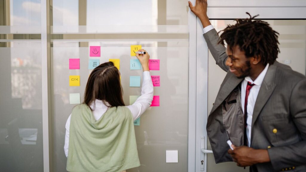 Tech team planning a no-code marketplace migration roadmap on a sticky note wall