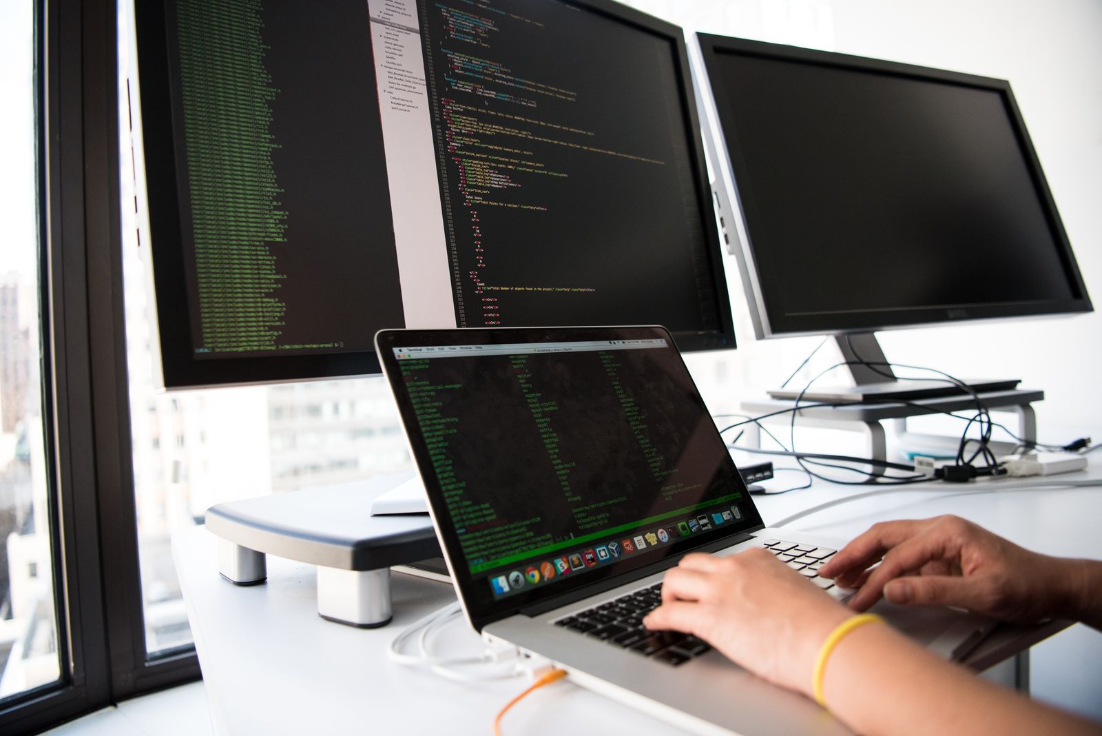 Developer comparing headless CMS options across multiple screens