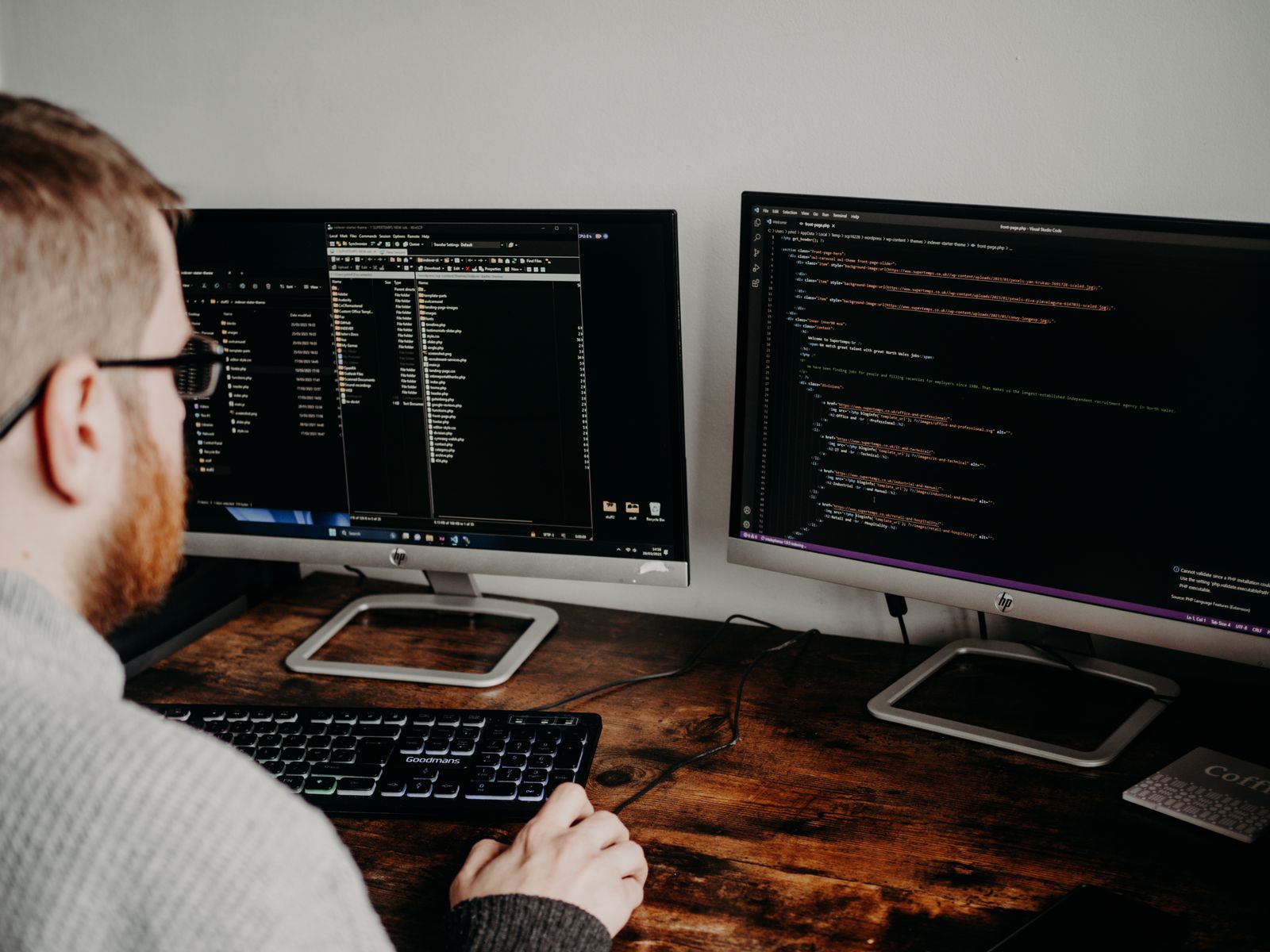 Developer managing a software project across two monitors