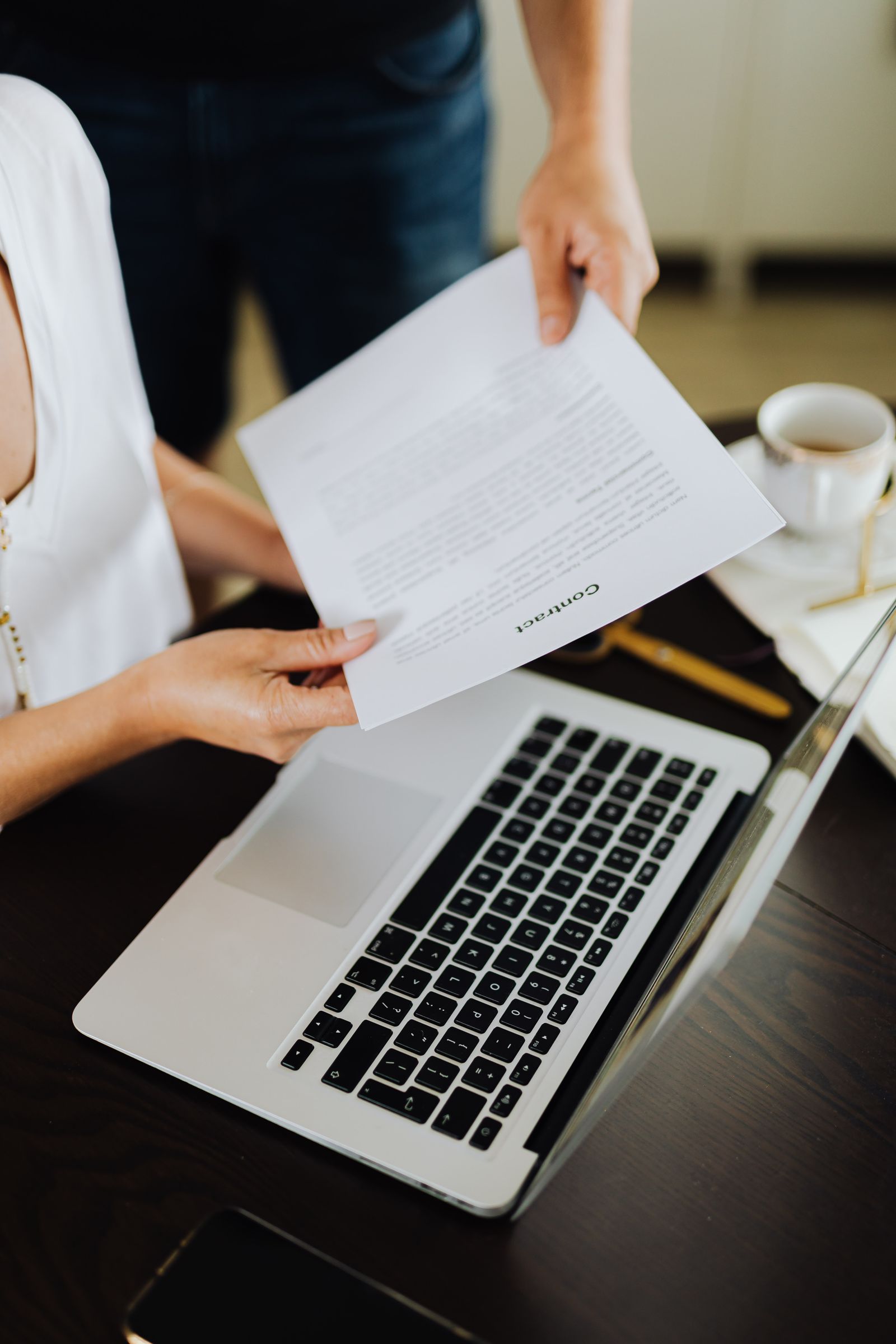 Reviewing an RFQ ecommerce quote document alongside a laptop