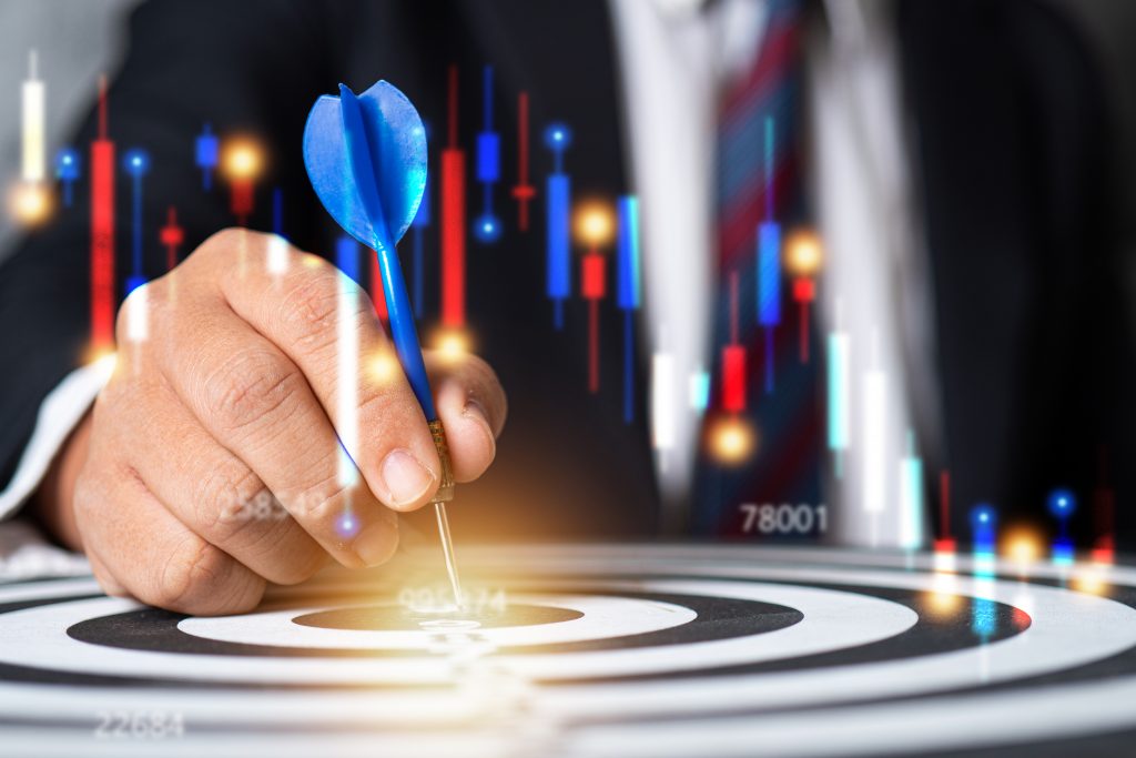 Business man put target on dart board, stock market and finance