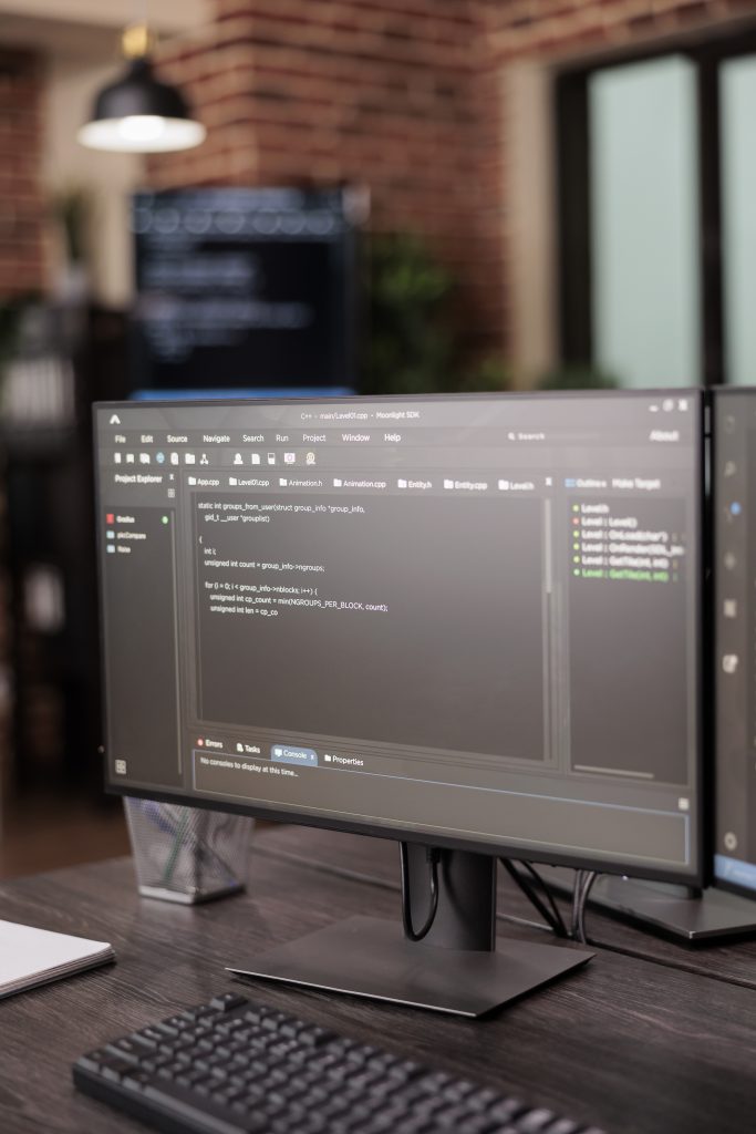 Computer monitors showing source code