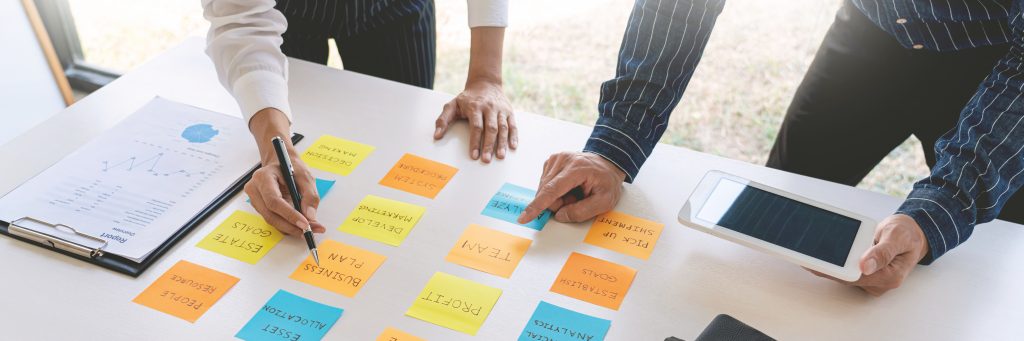 young business workers posting with sticky notes stickers remind