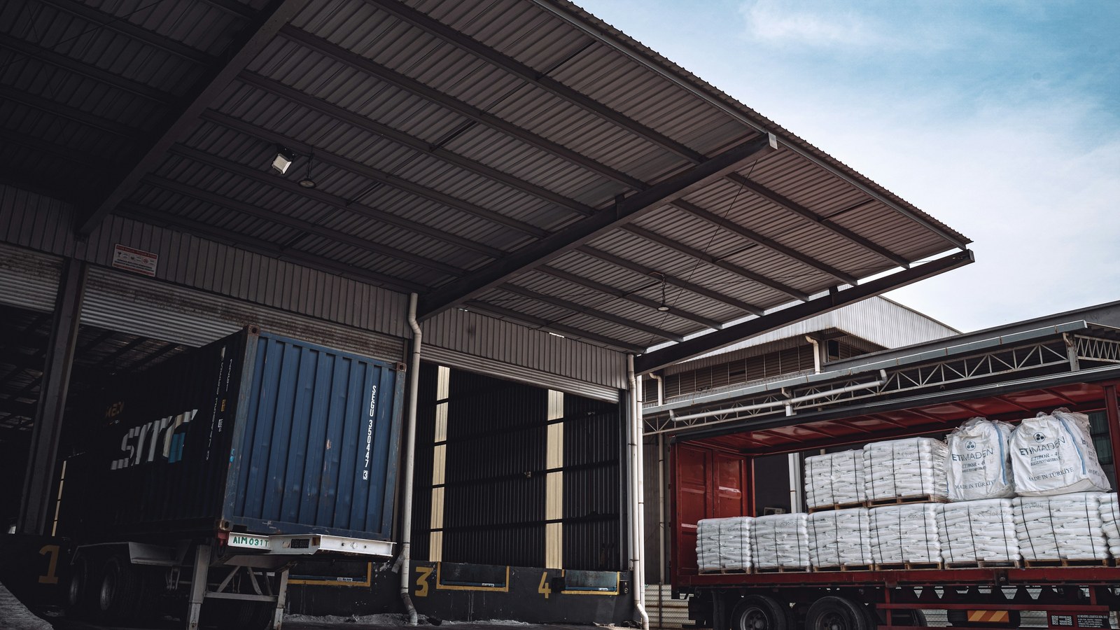 Semi-trailer at a warehouse loading dock being loaded with palletised bulk bags for a B2B order