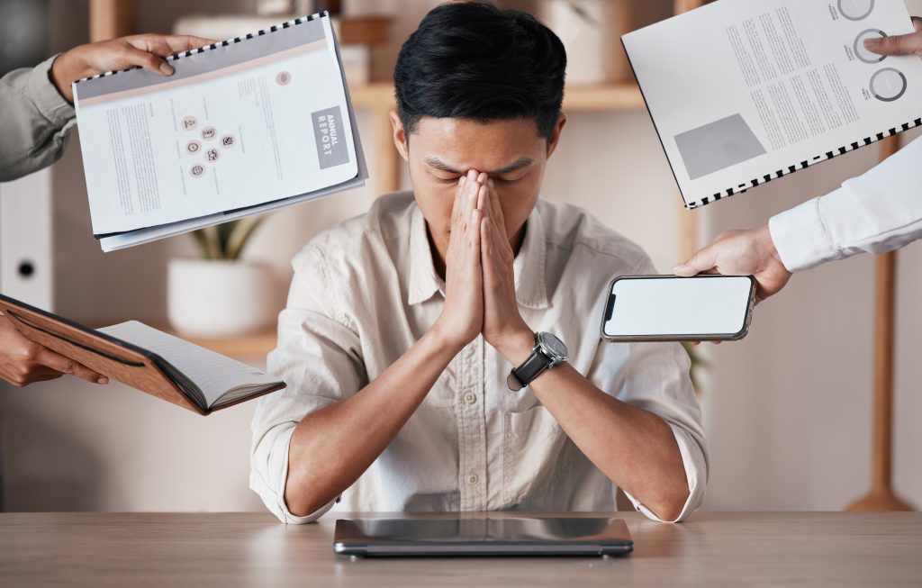 stress burnout tired businessman overworked overwhelmed frustrated by his manager office headache chaos stressed out asian worker trouble struggle mental health problems