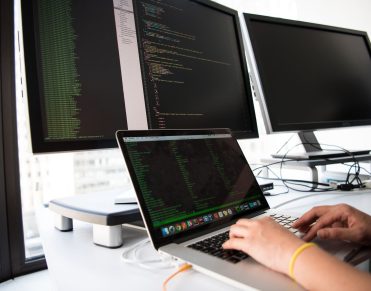 Developer comparing headless CMS options across multiple screens